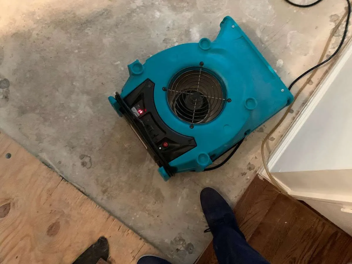 Air mover drying subfloor during Leak Detection & Repair in La Porte